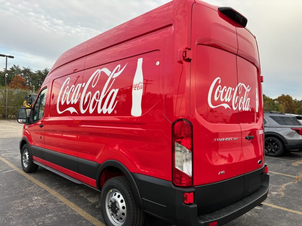 red coca-cola branded conversion van - view from the driver side rear corner