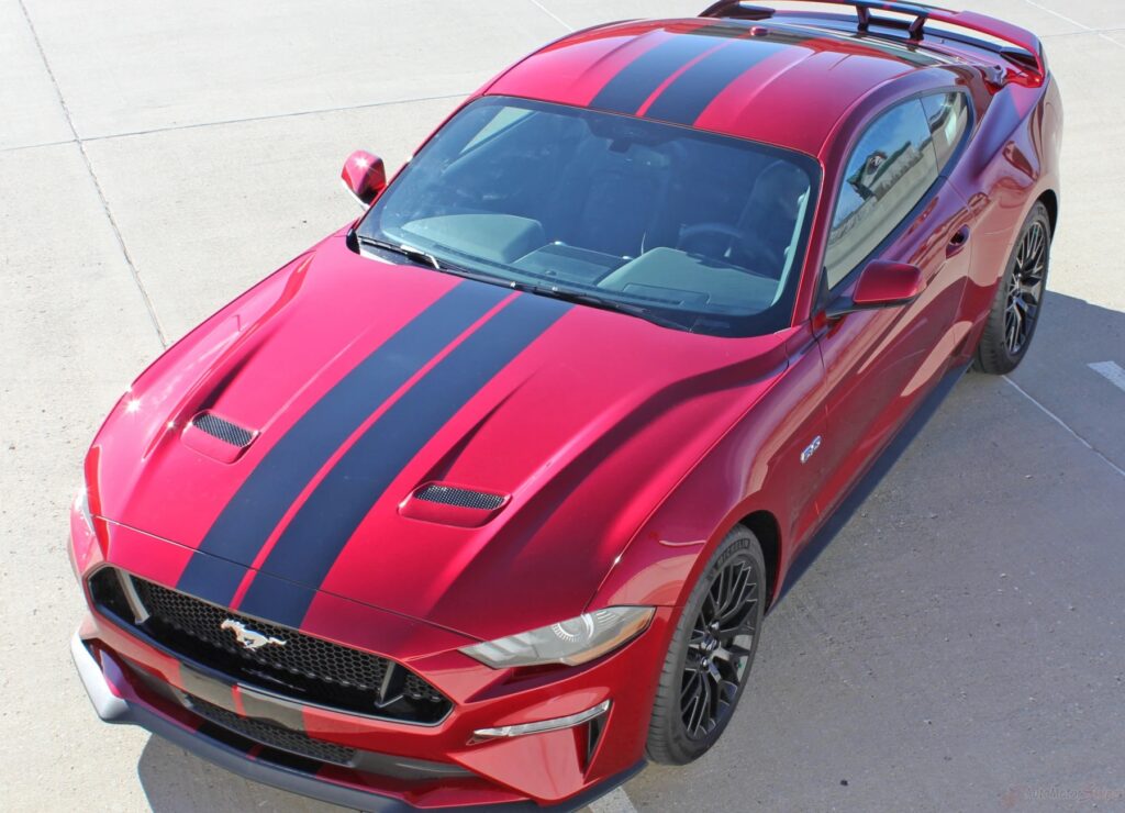 Red Mustang with black racing pinstripes, featuring a mobile PPF and vinyl graphics installation for Ford/Mustang dealerships.
